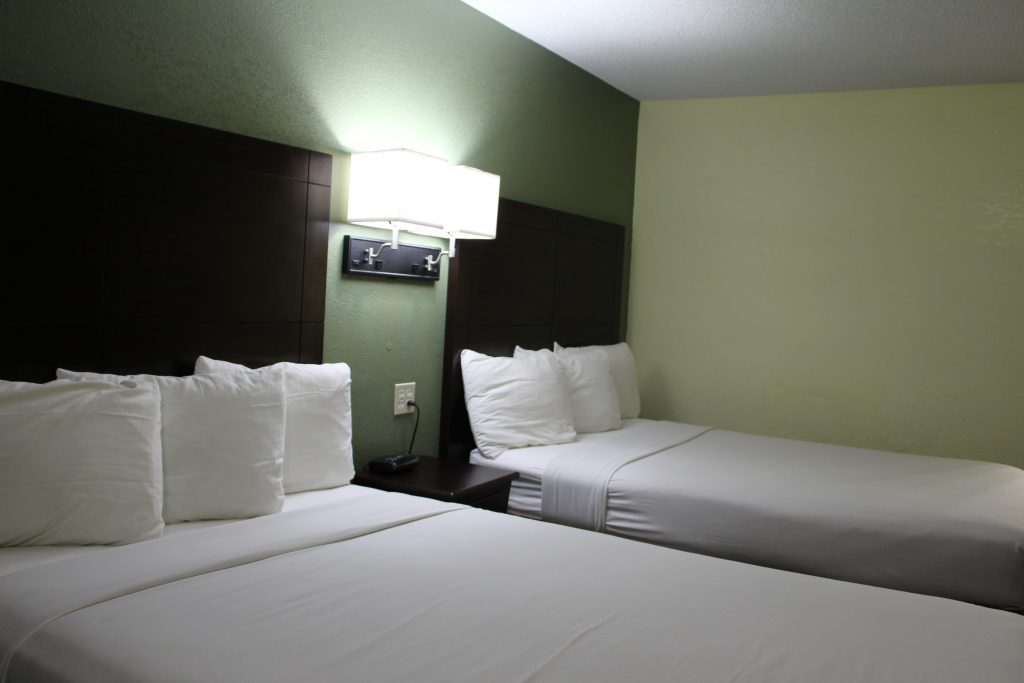 Two comfortable queen beds with crisp white linens