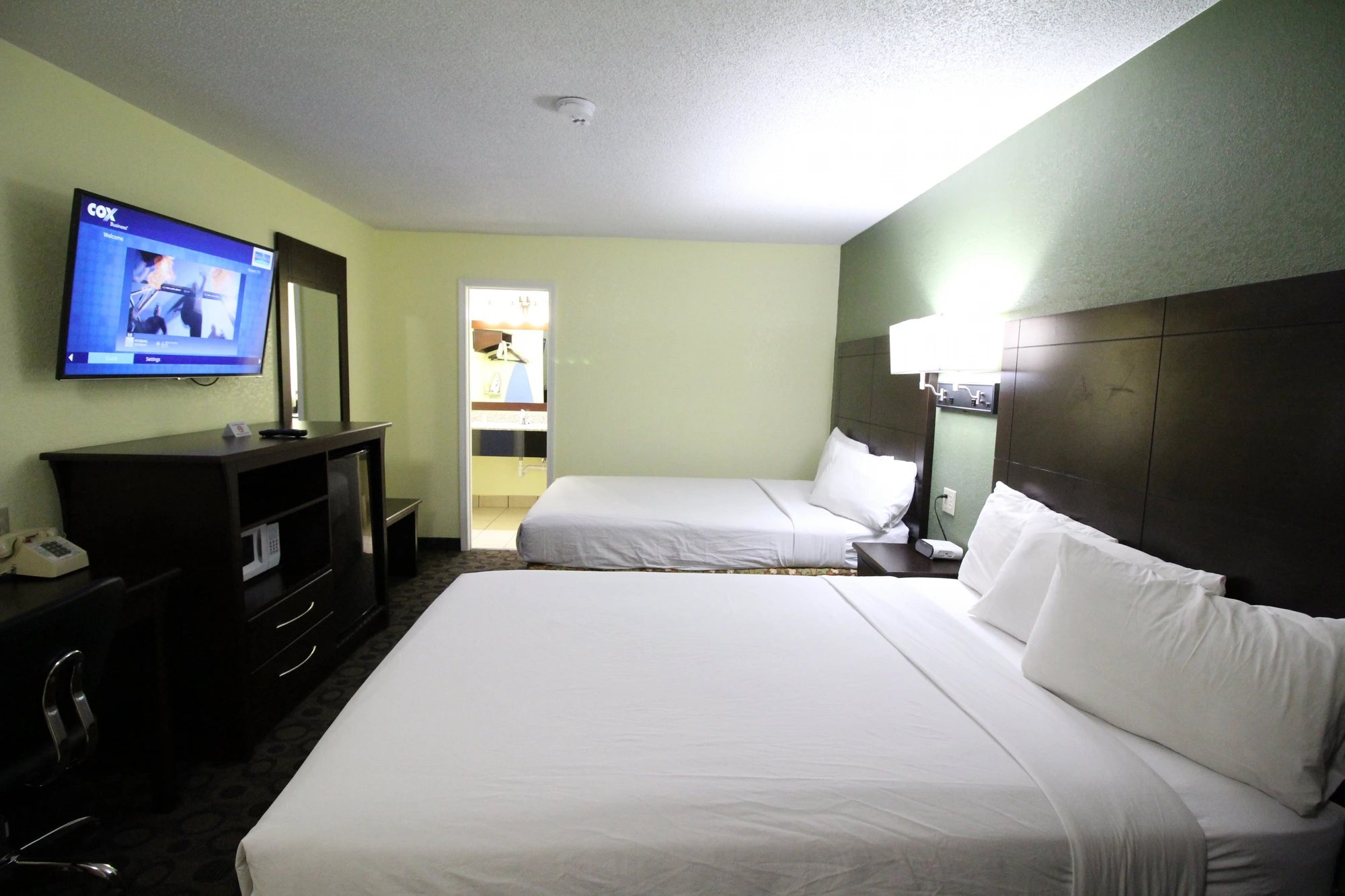 Two queen room with 50-inch LED TV, mirror and en-suite bathroom